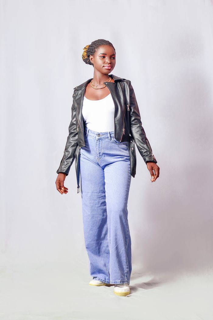 services-03 Stylish young woman in denim and leather jacket posing in studio setting.
